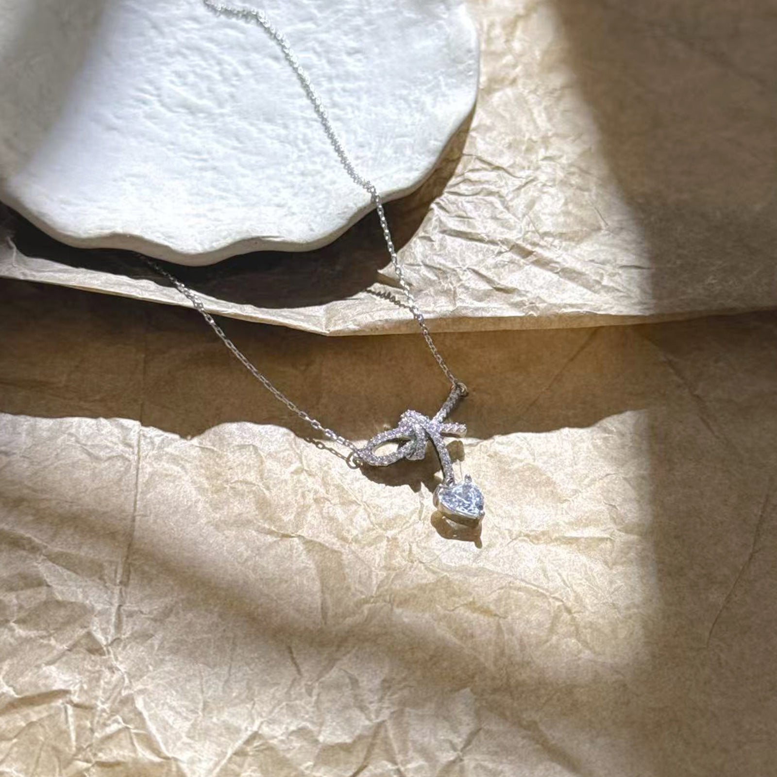Pavé CZ Ribbon Knot Heart Cut Drop Pendant Necklace | Silver Plated Brass | Wholesale OEM